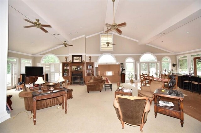 living room with lofted ceiling with beams, light colored carpet, and ornamental molding