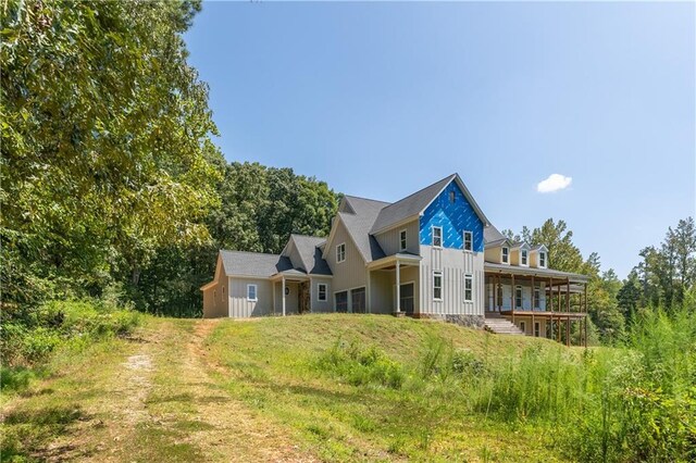 back of property with a porch