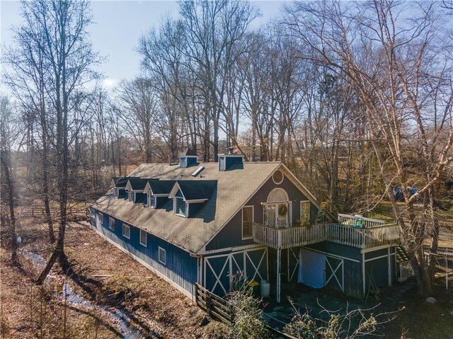 rear view of property featuring a wooden deck