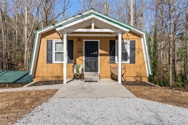 view of front of house featuring entry steps and a gambrel roof