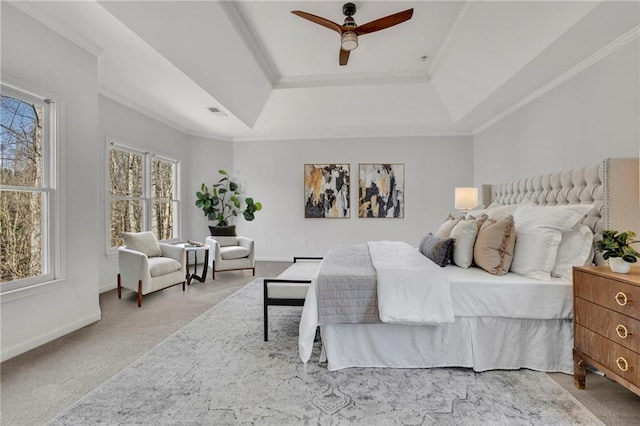 bedroom featuring baseboards, a raised ceiling, visible vents, and crown molding