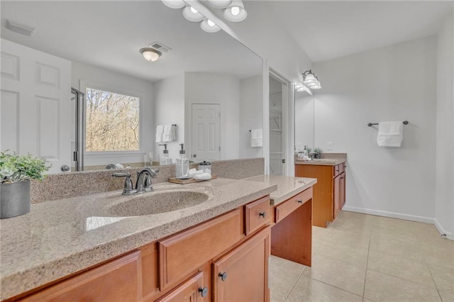 full bath featuring two vanities, visible vents, a sink, tile patterned flooring, and baseboards