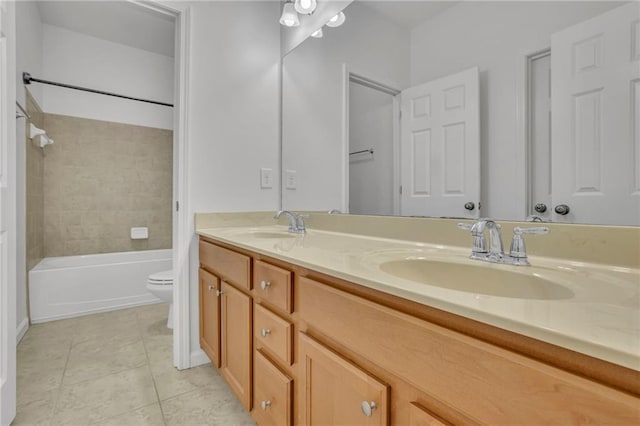 full bath with tile patterned flooring, a sink, toilet, and double vanity