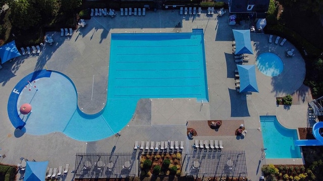 view of swimming pool featuring fence