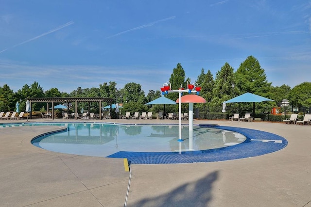 community pool with a patio, fence, and a pergola