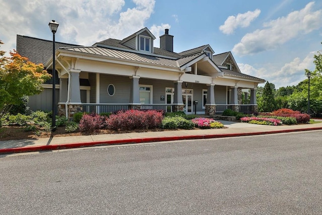 view of front of house featuring a porch, a standing seam roof, and metal roof