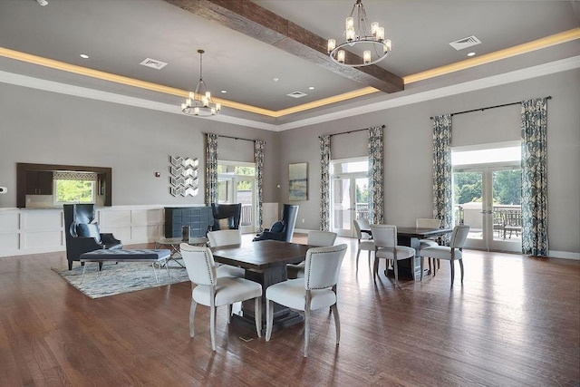 dining area featuring french doors, visible vents, a notable chandelier, and wood finished floors