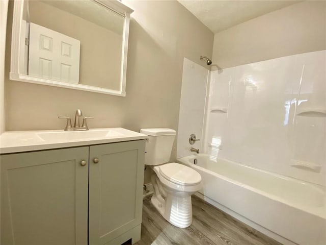 full bathroom featuring vanity, wood-type flooring, shower / tub combination, and toilet