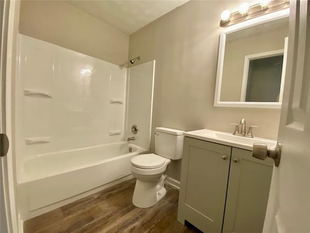 full bathroom with wood-type flooring, tub / shower combination, vanity, and toilet