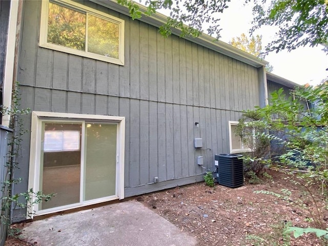 view of side of home featuring central AC