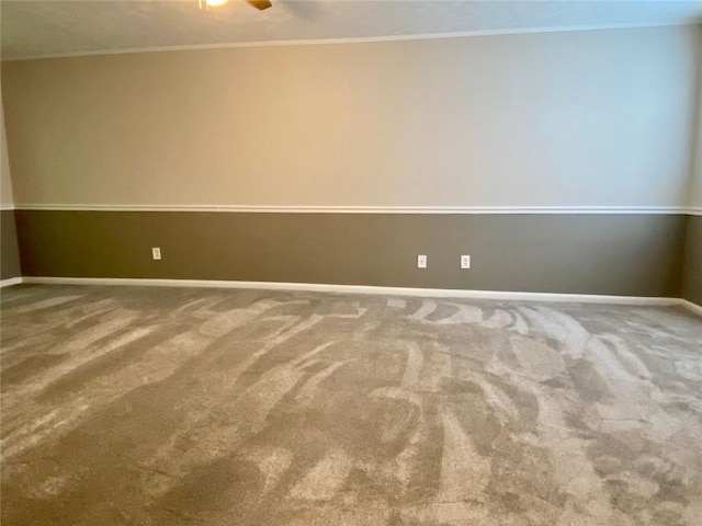 carpeted empty room with crown molding and ceiling fan