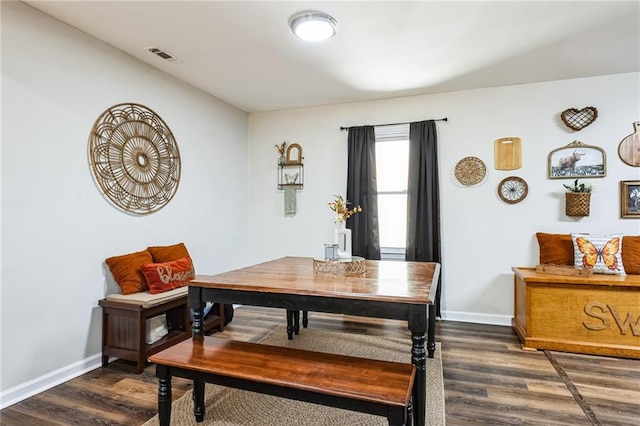 dining area with dark hardwood / wood-style floors