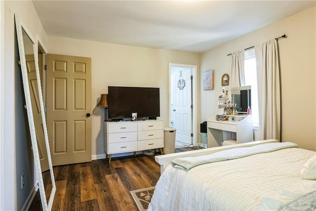 bedroom with dark hardwood / wood-style floors