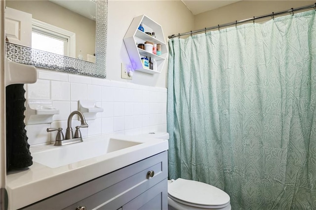 bathroom featuring tile walls, vanity, decorative backsplash, and toilet