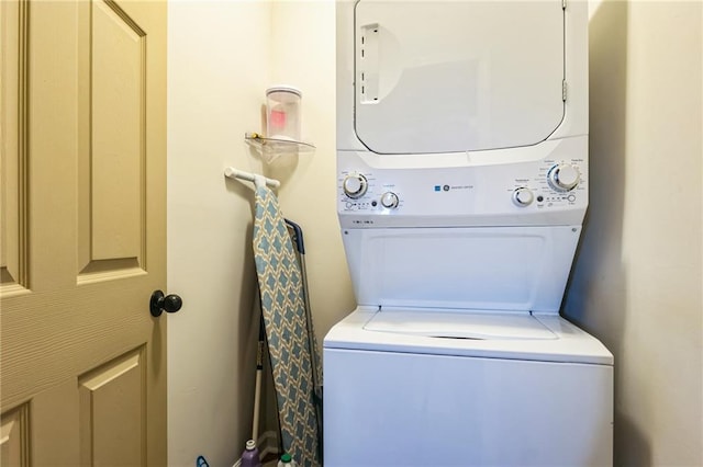 washroom featuring stacked washer / dryer