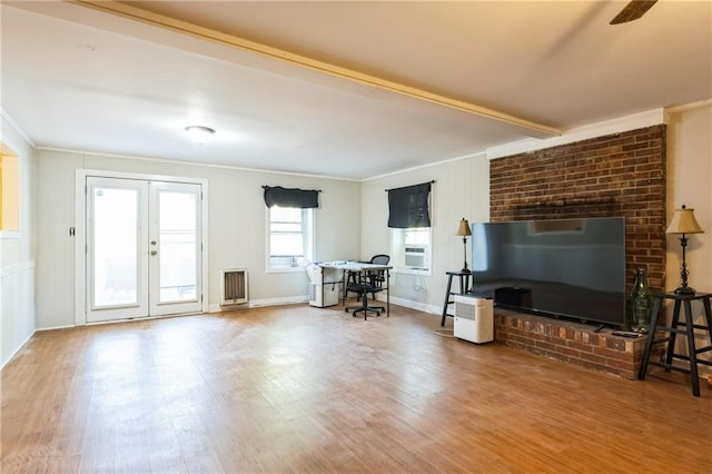 living room featuring crown molding, wood-type flooring, french doors, and beamed ceiling