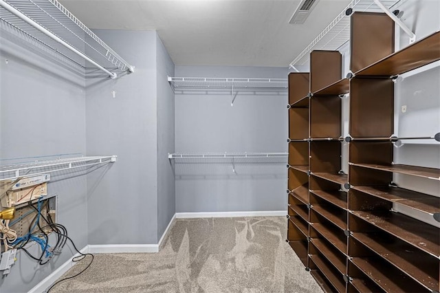 walk in closet with carpet floors and visible vents