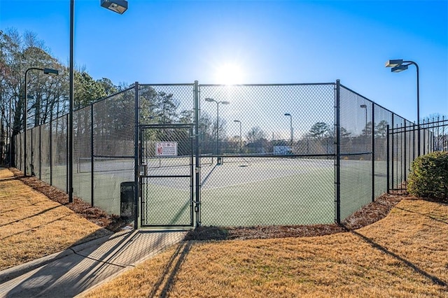 view of sport court featuring a gate and fence