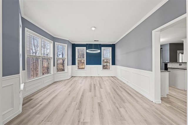 interior space featuring ornamental molding, a wealth of natural light, and wood finished floors