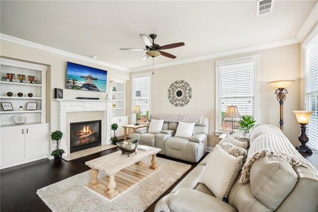 4155 Brookview Dr, Cumming, GA 30040 - living room with ceiling fan, dark wood-type flooring, ornamental molding, a fireplace with flush hearth, and built in features