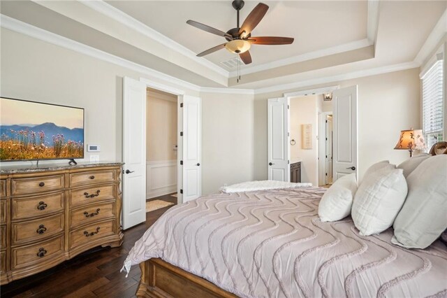4155 Brookview Dr, Cumming, GA 30040 - bedroom featuring a tray ceiling, dark wood-type flooring, ornamental molding, ensuite bathroom, and a wainscoted wall