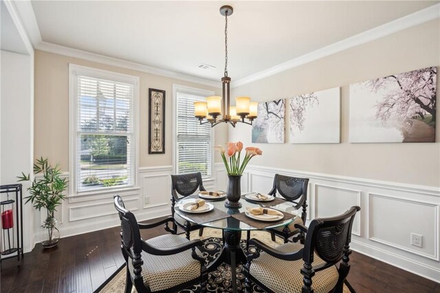 4155 Brookview Dr, Cumming, GA 30040 - dining room featuring a chandelier, dark wood-style flooring, wainscoting, crown molding, and a decorative wall