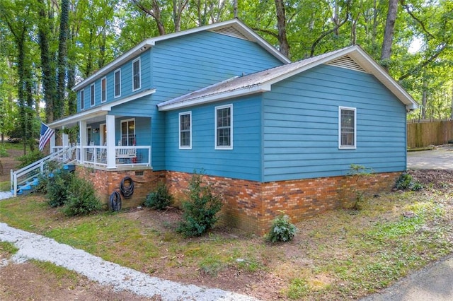 view of side of home featuring a porch