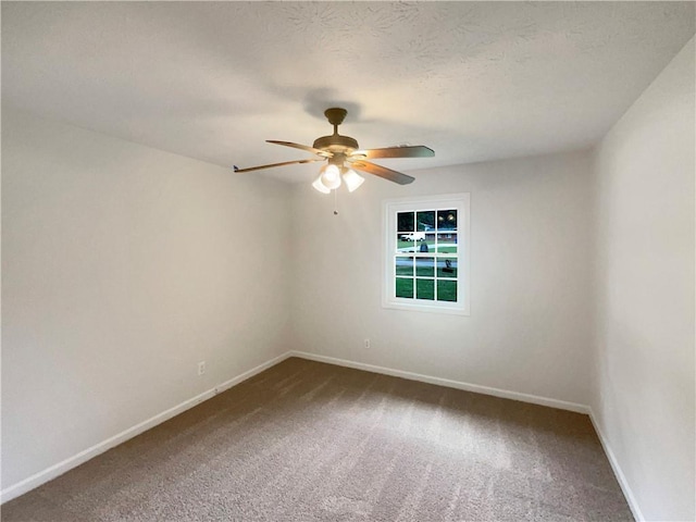 carpeted spare room with baseboards, a textured ceiling, and ceiling fan