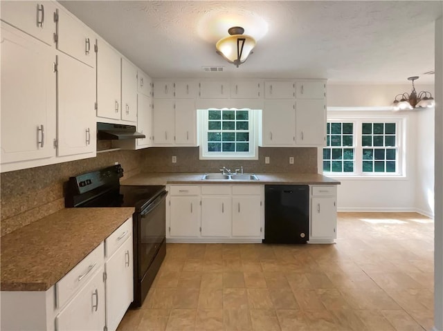 kitchen featuring visible vents, black appliances, under cabinet range hood, a sink, and decorative backsplash