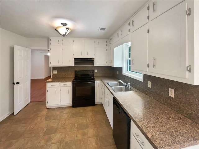 kitchen with visible vents, black appliances, a sink, white cabinetry, and decorative backsplash