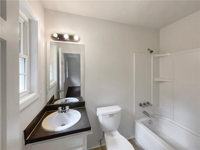 bathroom featuring shower / tub combination, vanity, and toilet