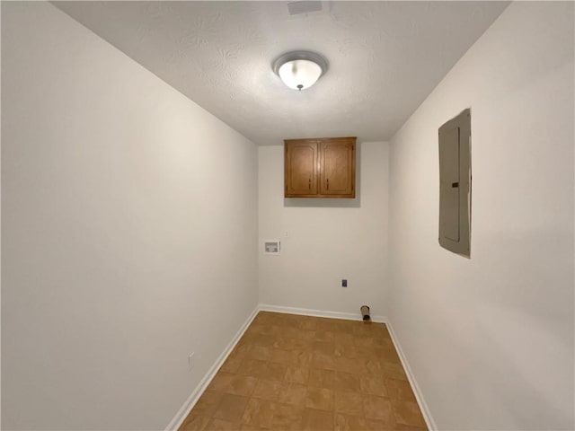 laundry area with electric panel, baseboards, cabinet space, and hookup for a washing machine