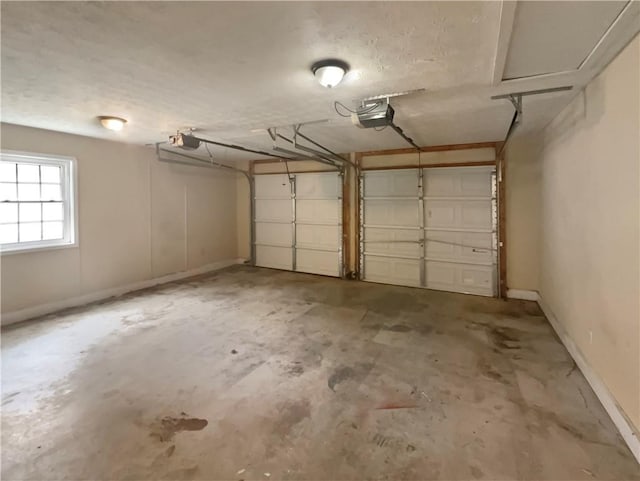 garage with a garage door opener and baseboards