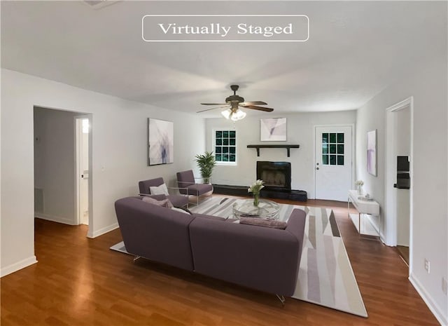 living room with dark wood-type flooring and ceiling fan