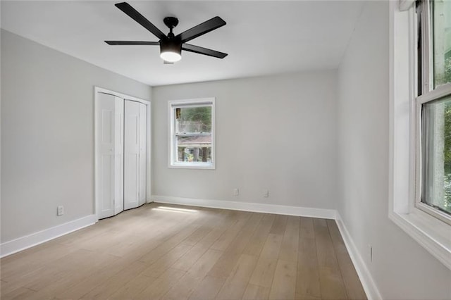 unfurnished bedroom with a ceiling fan, baseboards, and wood finished floors