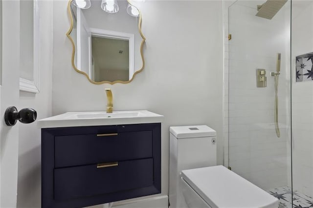 full bathroom featuring toilet, tiled shower, and vanity