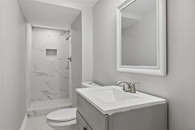full bathroom featuring vanity, marble finish floor, toilet, and a shower stall