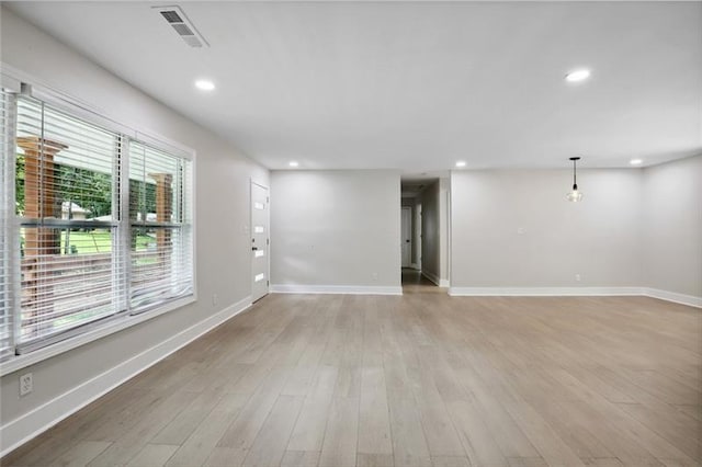 empty room featuring recessed lighting, baseboards, visible vents, and light wood finished floors