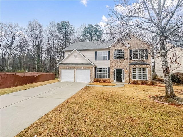 traditional home featuring concrete driveway, an attached garage, fence, a front lawn, and brick siding