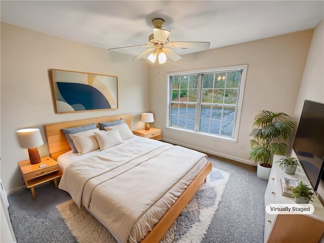 bedroom featuring dark colored carpet, a ceiling fan, and baseboards