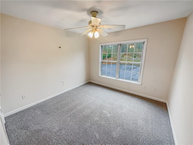 empty room featuring carpet, baseboards, and a ceiling fan