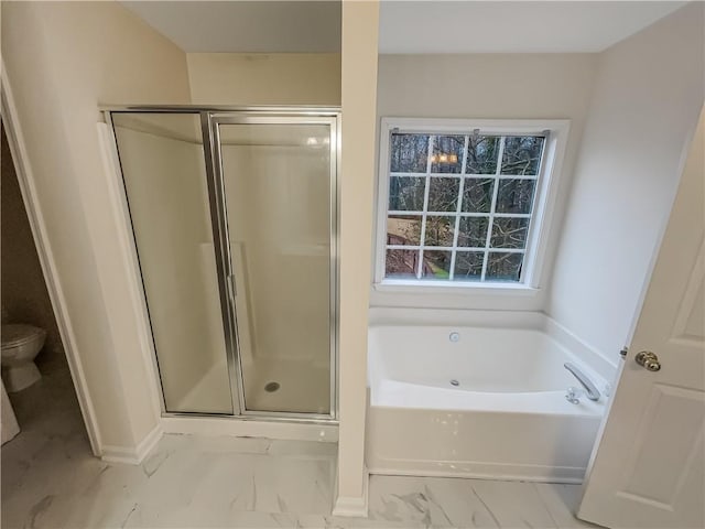 full bathroom featuring a stall shower, baseboards, toilet, marble finish floor, and a garden tub