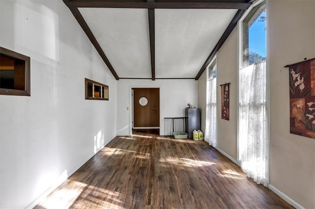 hall featuring hardwood / wood-style flooring, beam ceiling, and high vaulted ceiling