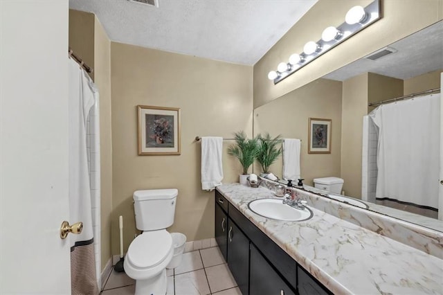 bathroom featuring tile patterned floors, vanity, and toilet