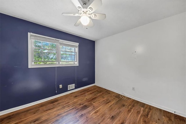 empty room with ceiling fan and hardwood / wood-style floors