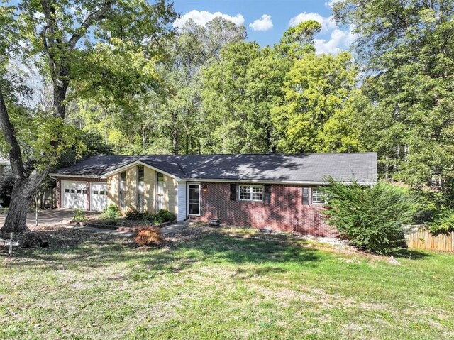 single story home with a garage and a front yard