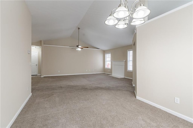 carpeted spare room with vaulted ceiling, baseboards, and ceiling fan with notable chandelier