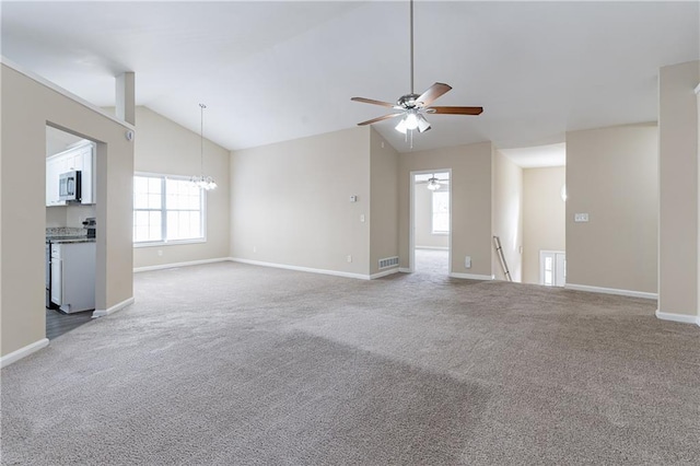 unfurnished living room featuring carpet floors, visible vents, vaulted ceiling, baseboards, and ceiling fan with notable chandelier