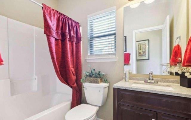 full bathroom with toilet, shower / tub combo, and vanity