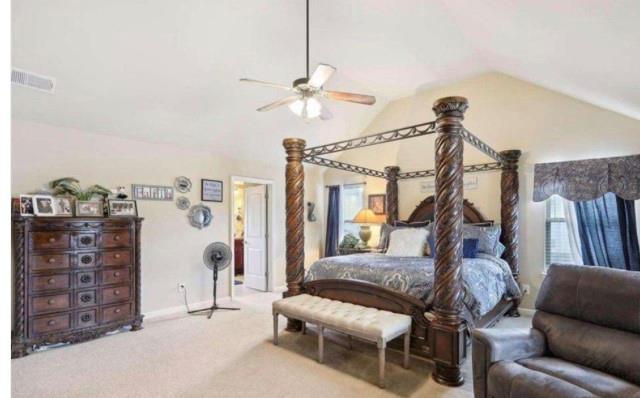 bedroom featuring ceiling fan, lofted ceiling, and carpet flooring